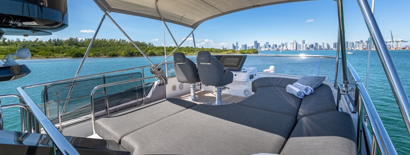 A suite of cushions on a luxury yacht awaiting guests overlooking the pristine Miami skyline